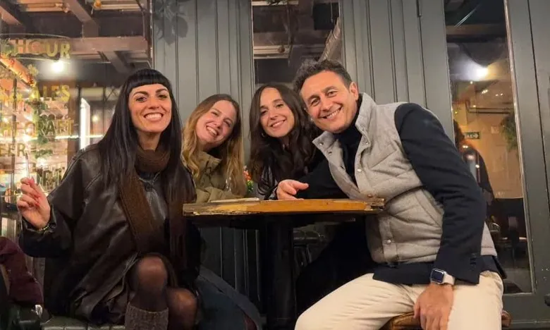 Francesca Colangelo, Margherita Spangaro, Giulia Mancuso and Enrico Ariotti of nCore HR in front of a wine bar in Paris